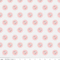 Pattern of pink flowers with scalloped edges on an off-white background