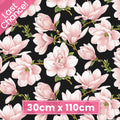 High-contrast fabric featuring large blush pink magnolia blossoms repeating on a black background