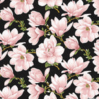 Blush pink magnolia blossoms repeating on a black cotton fabric background for quilting sewing projects