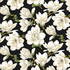 High-contrast fabric featuring large cream/white magnolia blossoms repeating on a black background