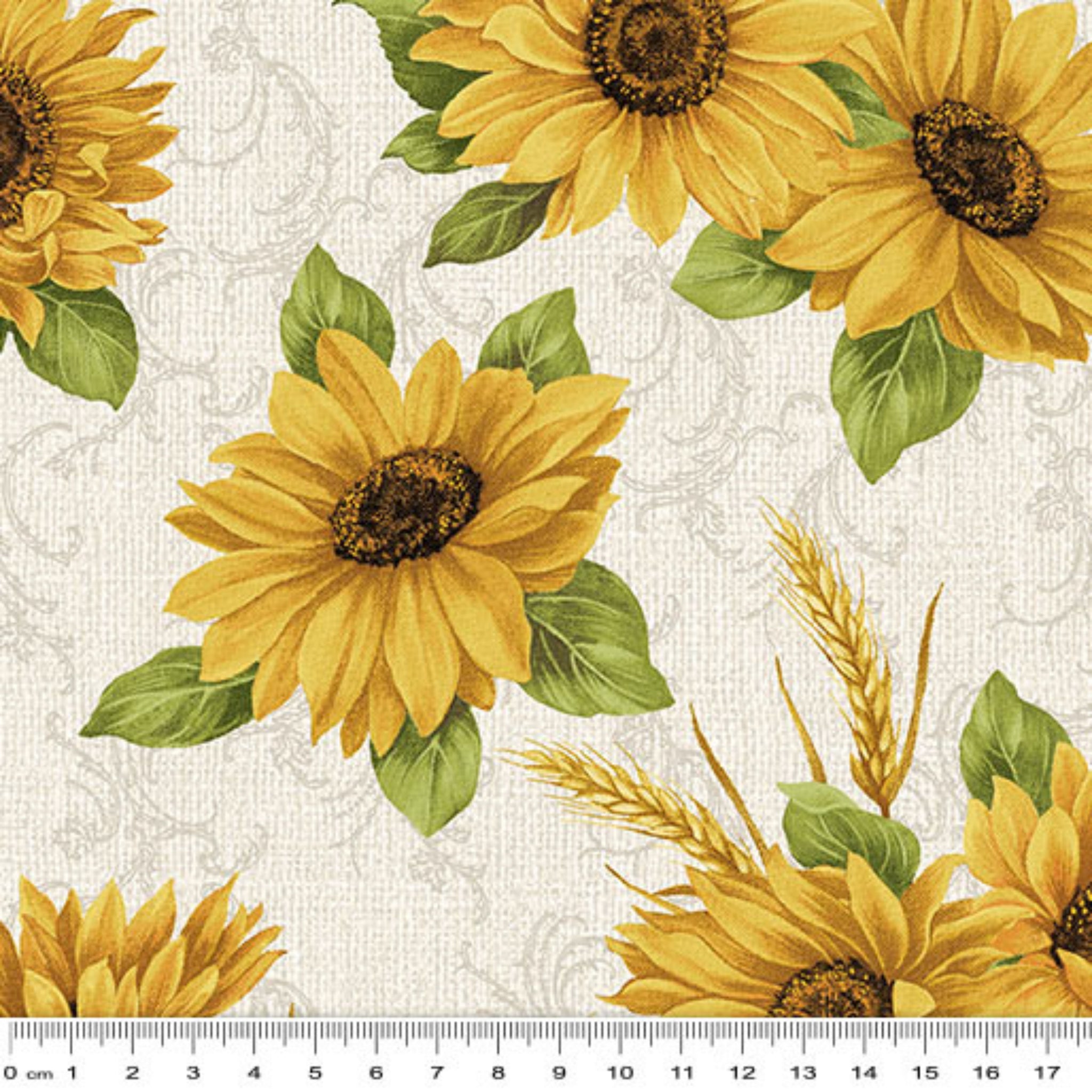 Quilting fabric with bright yellow sunflowers and wheat sheaves on a cream background