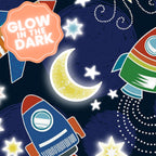 Navy blue fabric with colourful rockets, yellow moons, and stars that glow in the dark