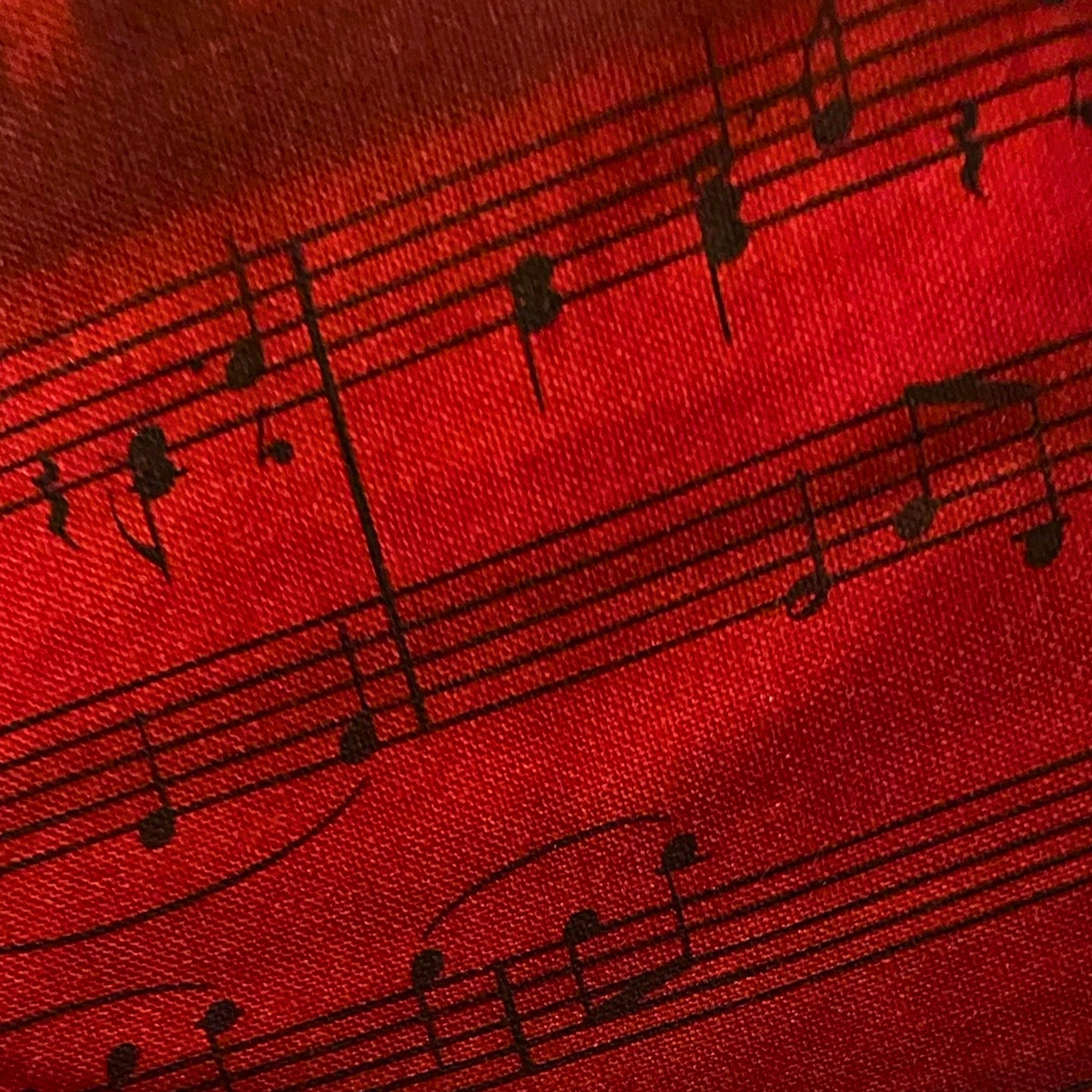 Screen printed vintage piano sheet music close-up red black Kona cotton weave music novelty fabric for quilts and patchwork sewing