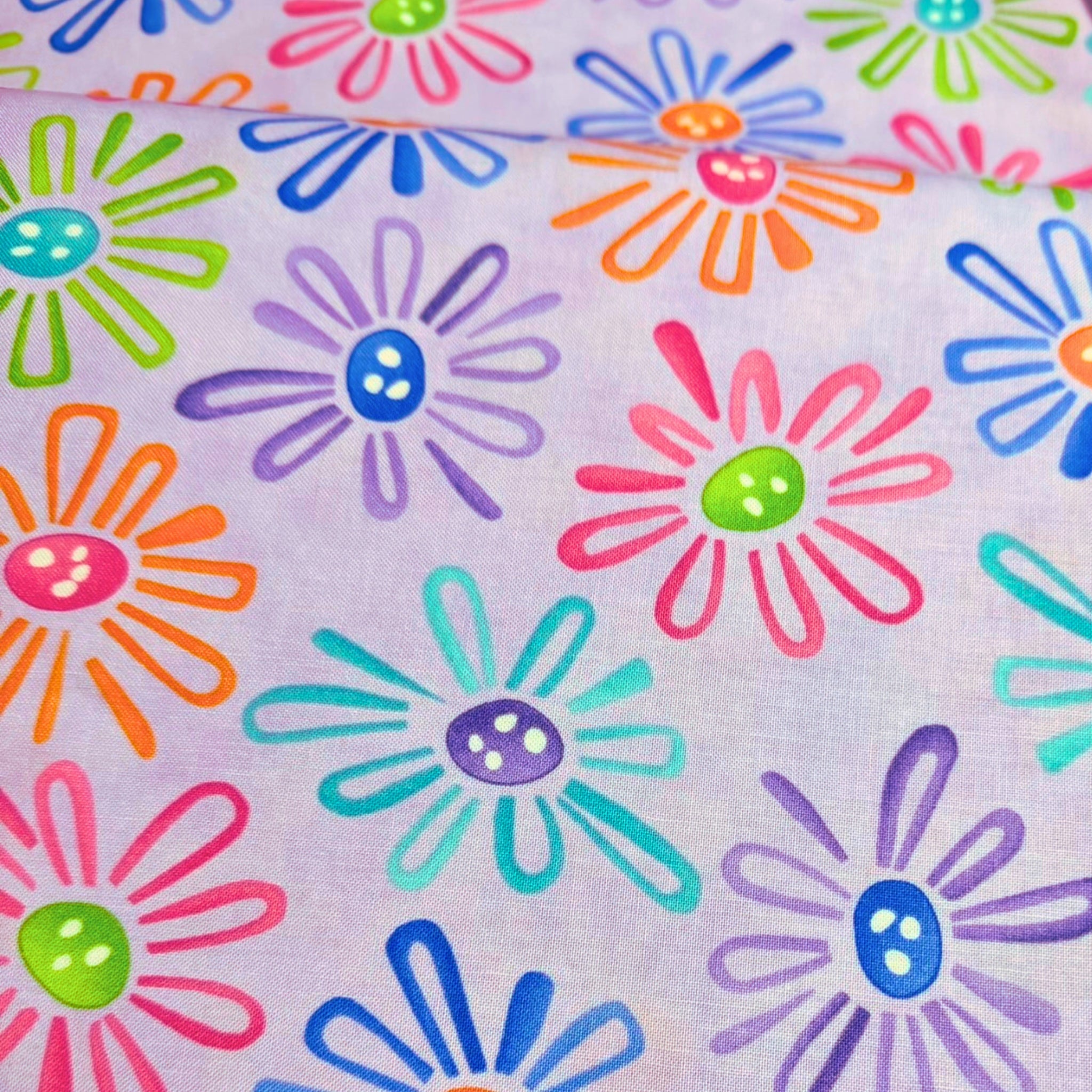 Multicolour novelty daisy flower print on lilac purple quilting cotton fabric for children's quilts and bright patchwork projects