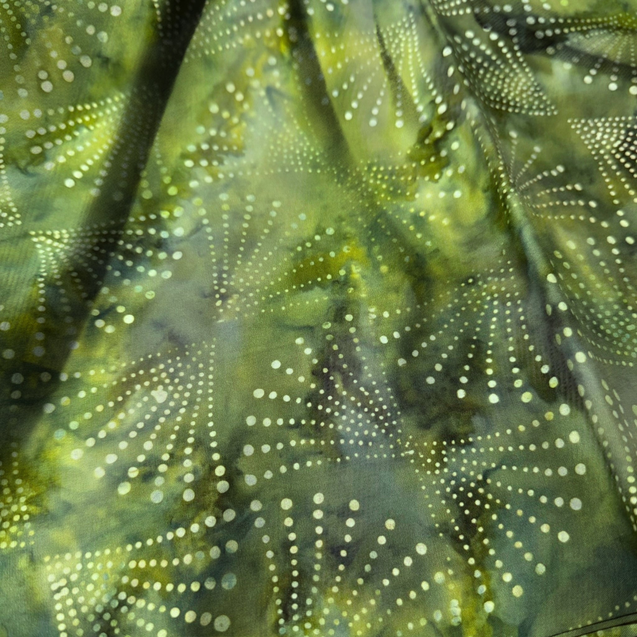 Radiating dots arcs green batik quilting fabric blender for patchwork quilts and sewing projects