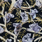 Realistic koalas eucalyptus gum trees golden branches black fabric for Australian themed quilts wildlife gifts and flora fauna patchwork sewing projects