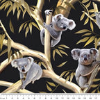 Realistic koalas eucalyptus gum trees golden branches black fabric for Australian themed quilts wildlife gifts and flora fauna patchwork sewing projects