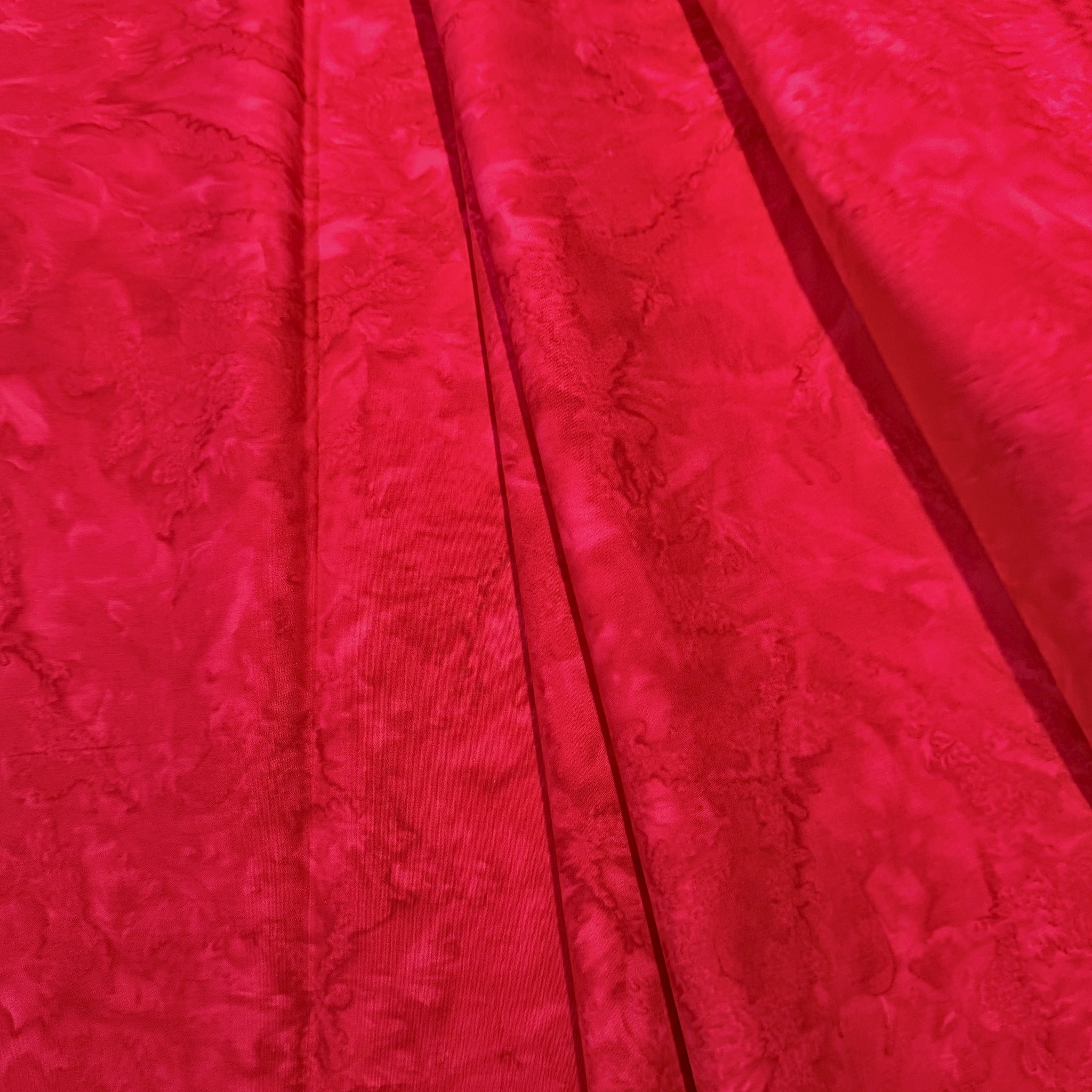 Vivid raspberry fuchsia pink red mottled batik blender fabric for quilt backgrounds sashing and scrappy batik quilts