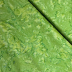 Bright kelly bamboo green mottled batik blender fabric with lime and forest green undertones for quilt backgrounds sashing and scrappy batik quilts