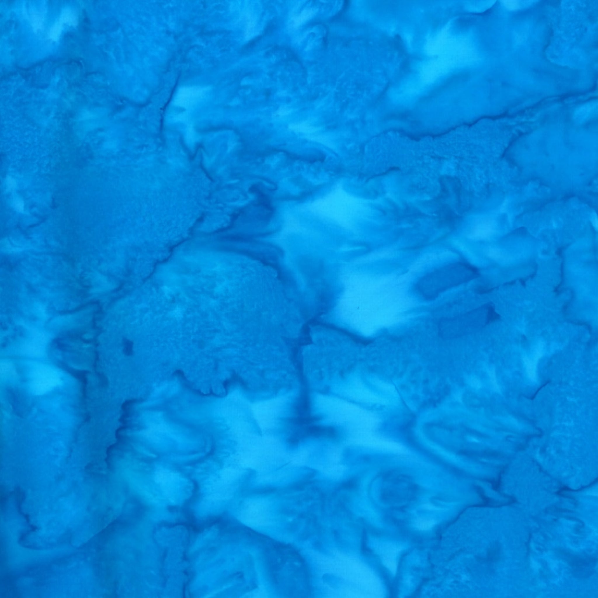 Vivid Bahama blue mottled batik blender fabric with sky blue and cobalt undertones for quilt backgrounds sashing and scrappy batik quilts