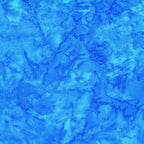 Vivid Bahama blue mottled batik blender fabric with sky blue and cobalt undertones for quilt backgrounds sashing and scrappy batik quilts