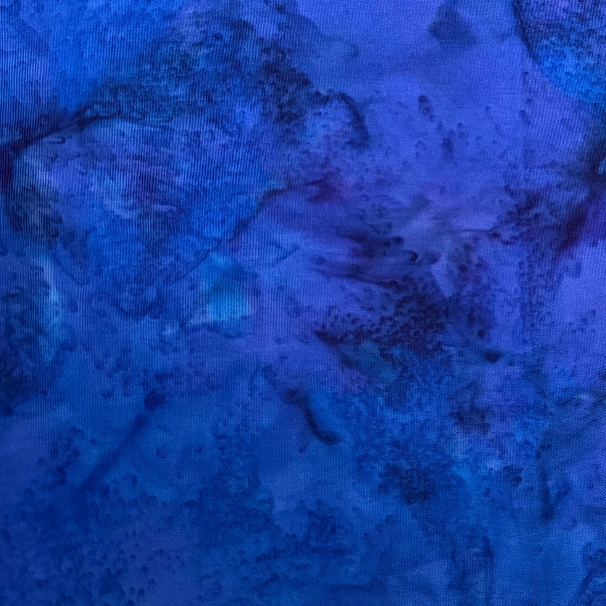 Deep violet blue mottled batik blender fabric with teal purple and navy undertones for quilt backgrounds sashing and scrappy batik quilts
