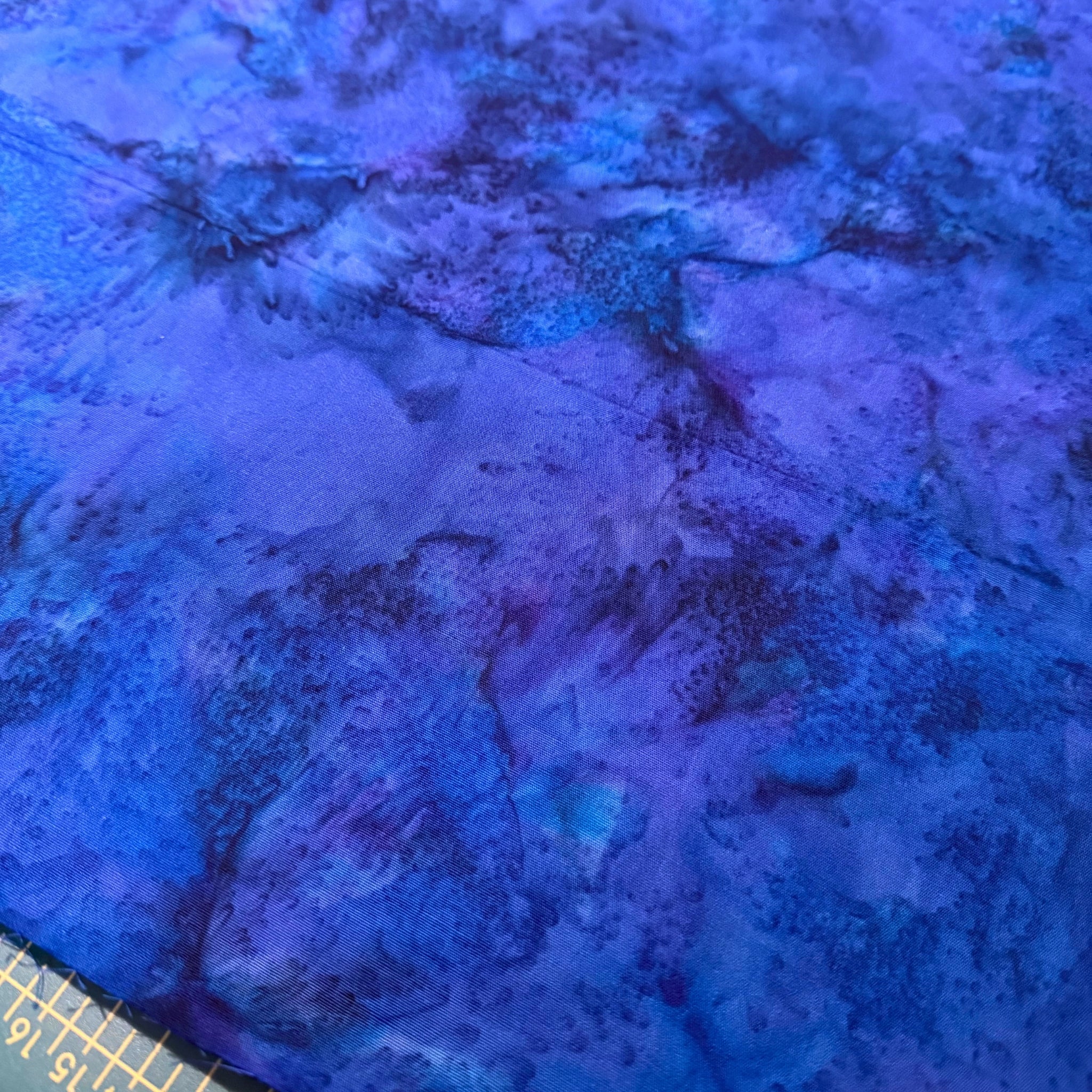 Deep violet blue mottled batik blender fabric with teal purple and navy undertones for quilt backgrounds sashing and scrappy batik quilts