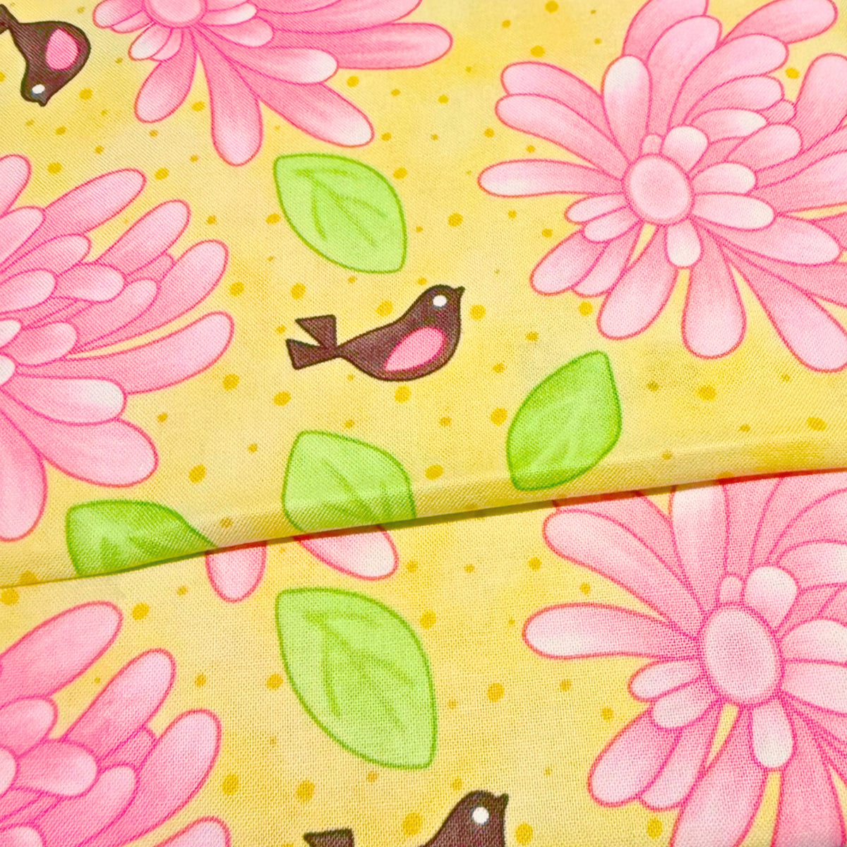 Pink flowers and brown birds with green leaves on yellow quilting fabric for floral patchwork quilts borders cushion covers and tote bags