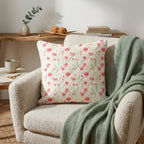 Quilted cushion cover sewn from Australian gum blossom fabric in pink and cream styled on neutral armchair with sage green throw