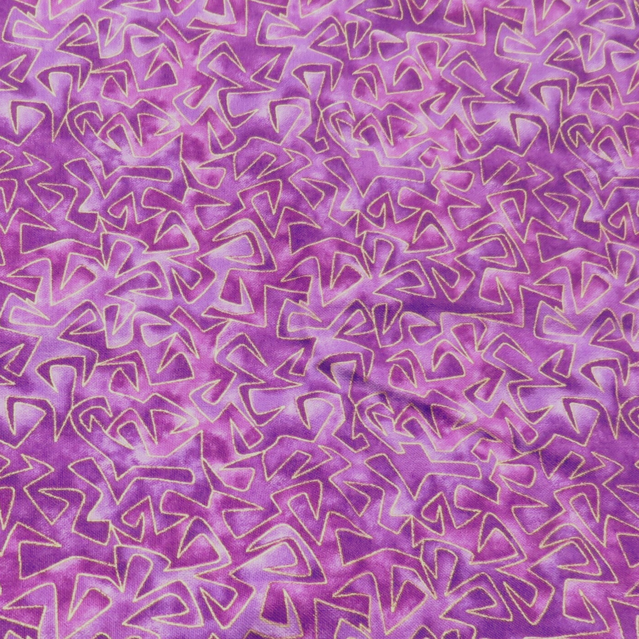 Tonal purple and pink fabric with all-over geometric triangular pattern with gold metallic