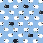 White and black sheep tossed flock blue background novelty quilting fabric for baby quilts nursery décor and children's sewing