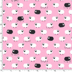 White and black sheep tossed flock pink background novelty quilting fabric for baby quilts nursery décor girls projects and children's sewing