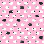 White and black sheep tossed flock pink background novelty quilting fabric for baby quilts nursery décor girls projects and children's sewing