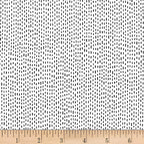 Scattered black dash stitch marks white background blender quilting fabric for backgrounds sashing baby quilts and patchwork projects