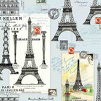 Fabric with Eiffel Tower illustrations and vintage postcard designs on a light blue background