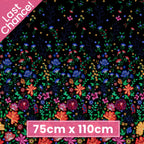 Embroidered-look floral border print black fabric graduating from small buds to bold blooms for quilt borders cushion covers tote bags and sewing projects