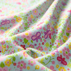 Tiny fairies butterflies pink and yellow flowers and green vines on blue novelty fabric for girls quilts nursery décor and patchwork sewing projects