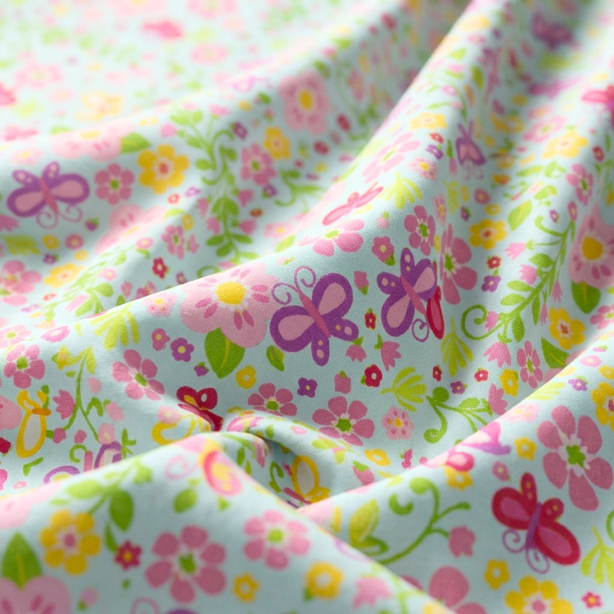 Tiny fairies butterflies pink and yellow flowers and green vines on blue novelty fabric for girls quilts nursery décor and patchwork sewing projects