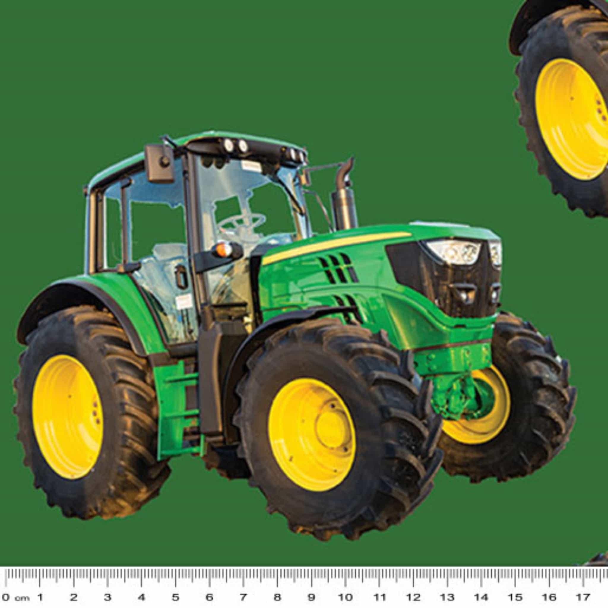Large green tractor fabric on solid green background, perfect for boys' quilting projects for farm lovers