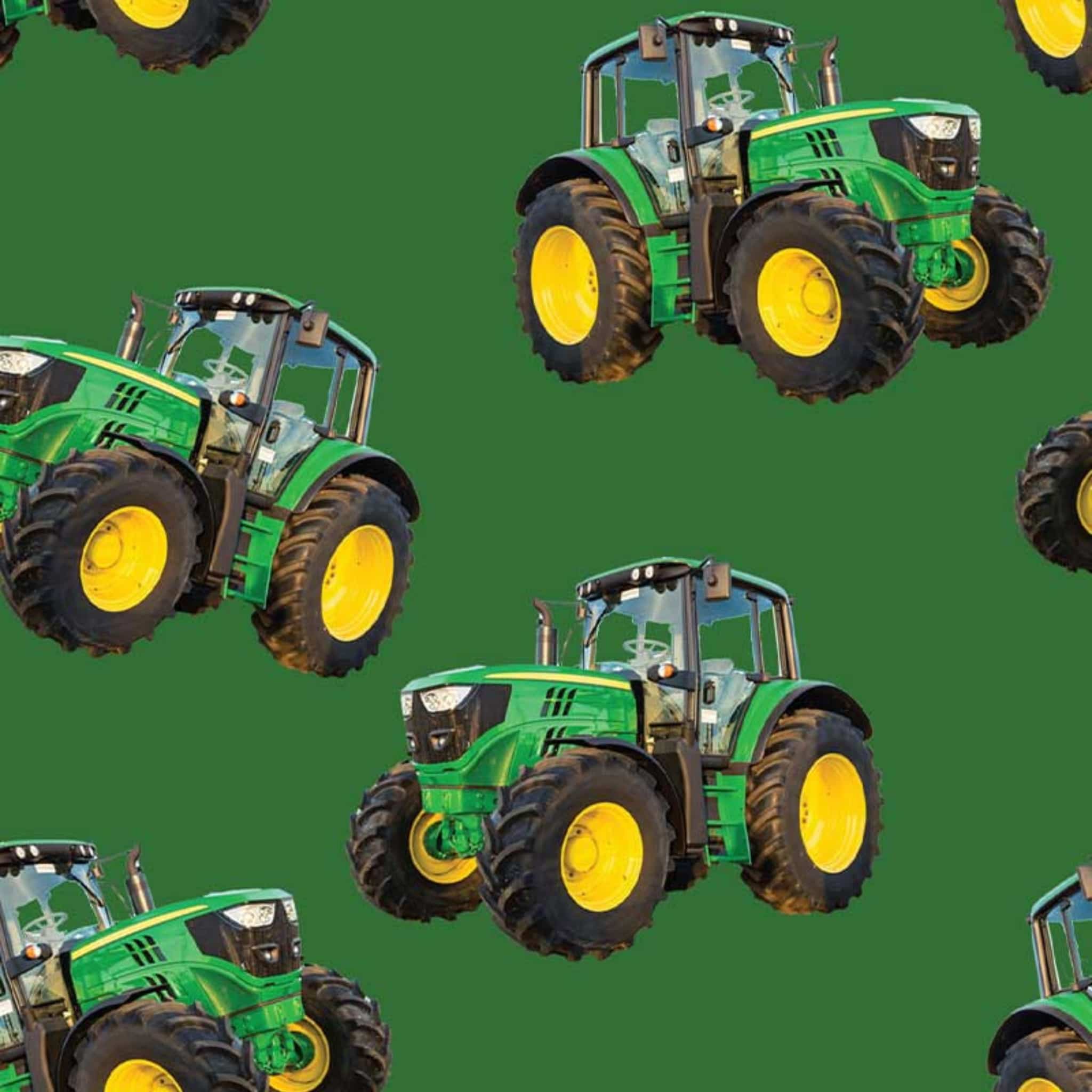 Large green tractor fabric on solid green background, perfect for boys' quilting projects for farm lovers