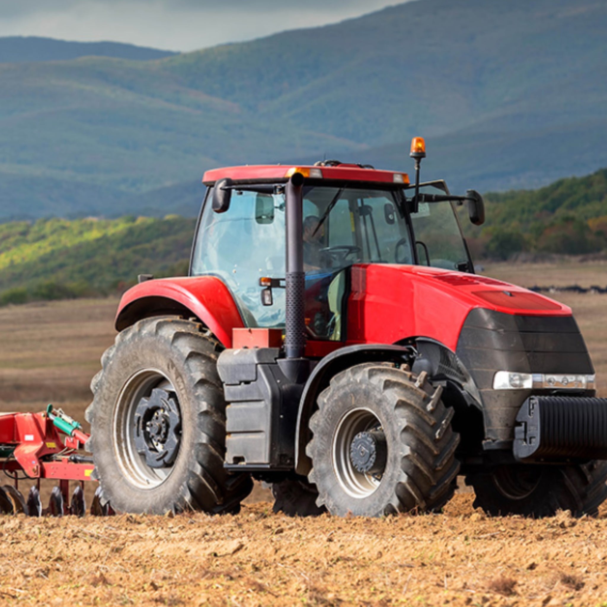 Red tractor panel fabric with detailed farm machinery, perfect for boys' quilting projects for farm lovers
