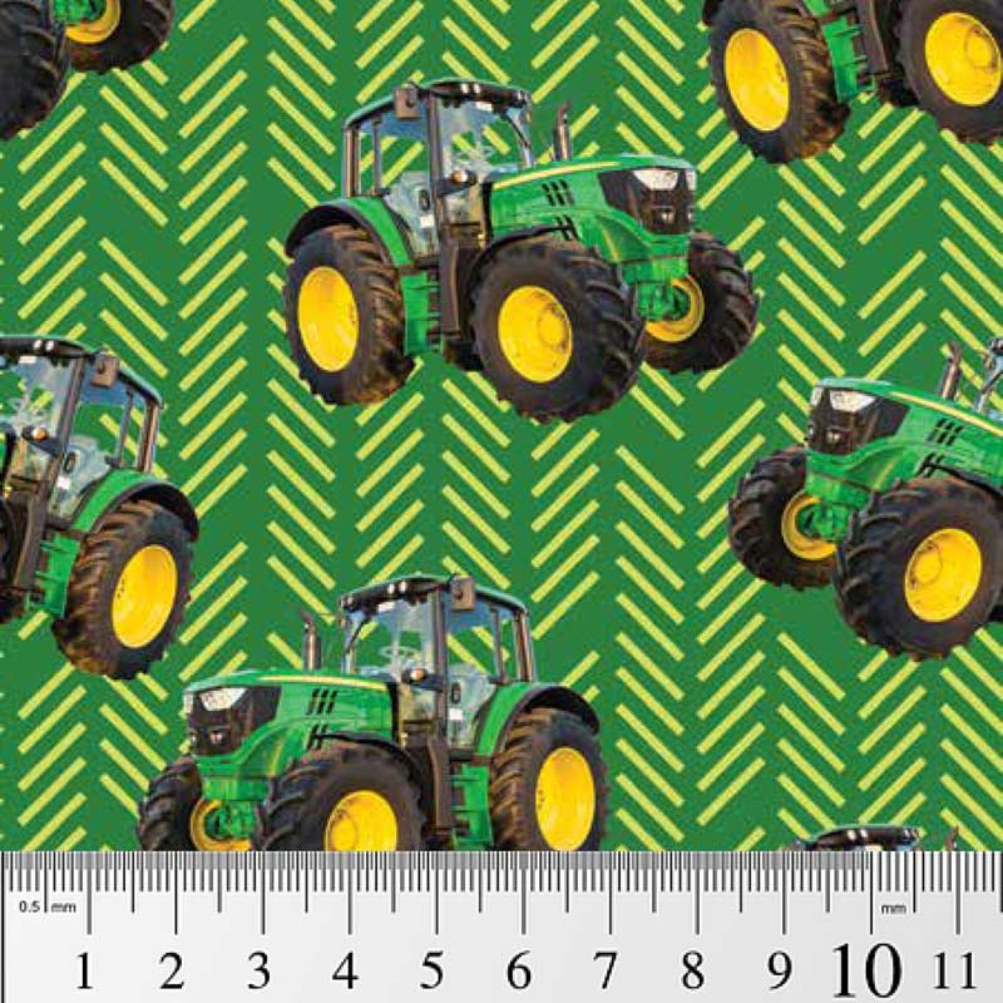 Green tractor toss fabric with patterned background, perfect for boys' quilting projects for farm lovers
