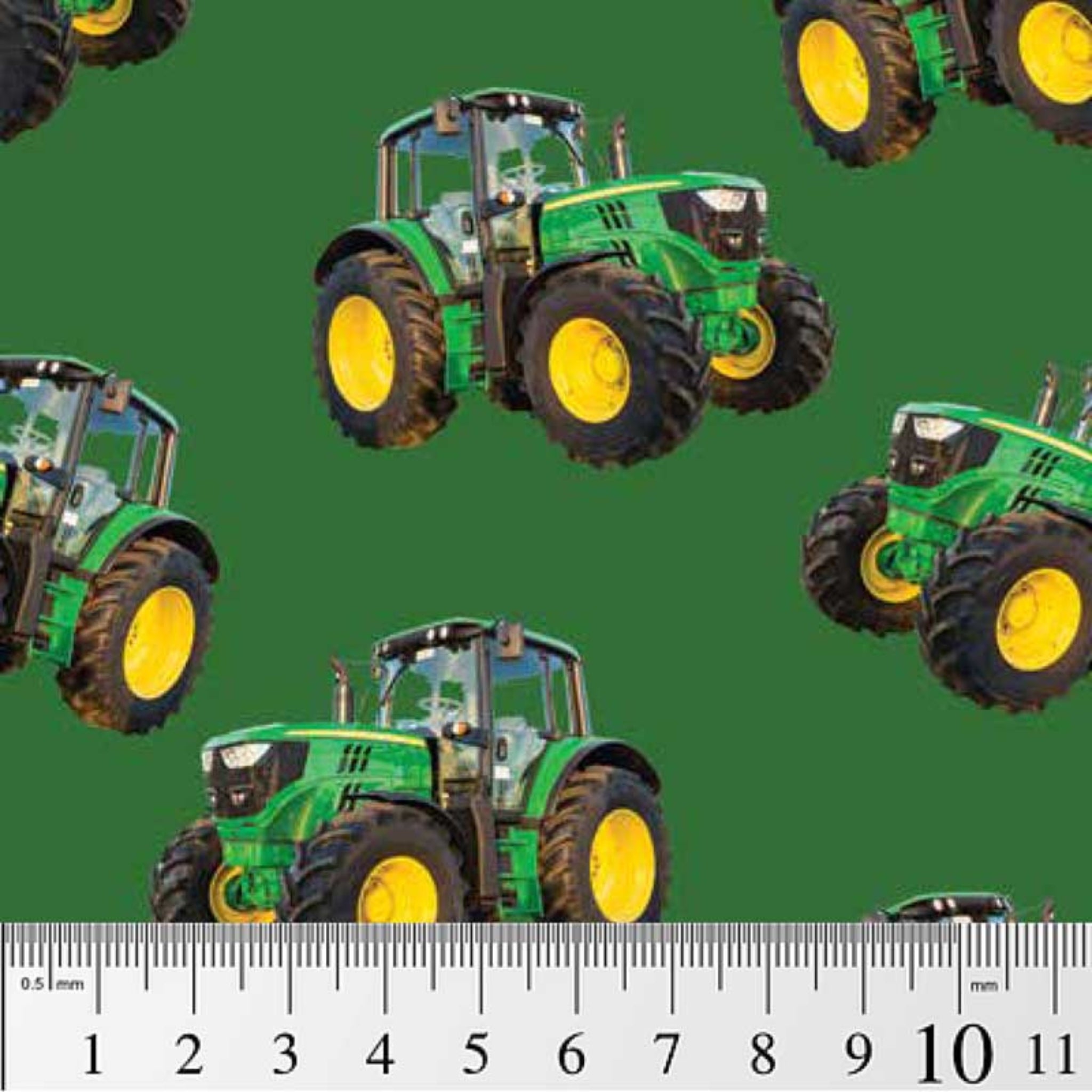 Green tractor toss fabric on solid green background, perfect for boys' quilting projects for farm lovers