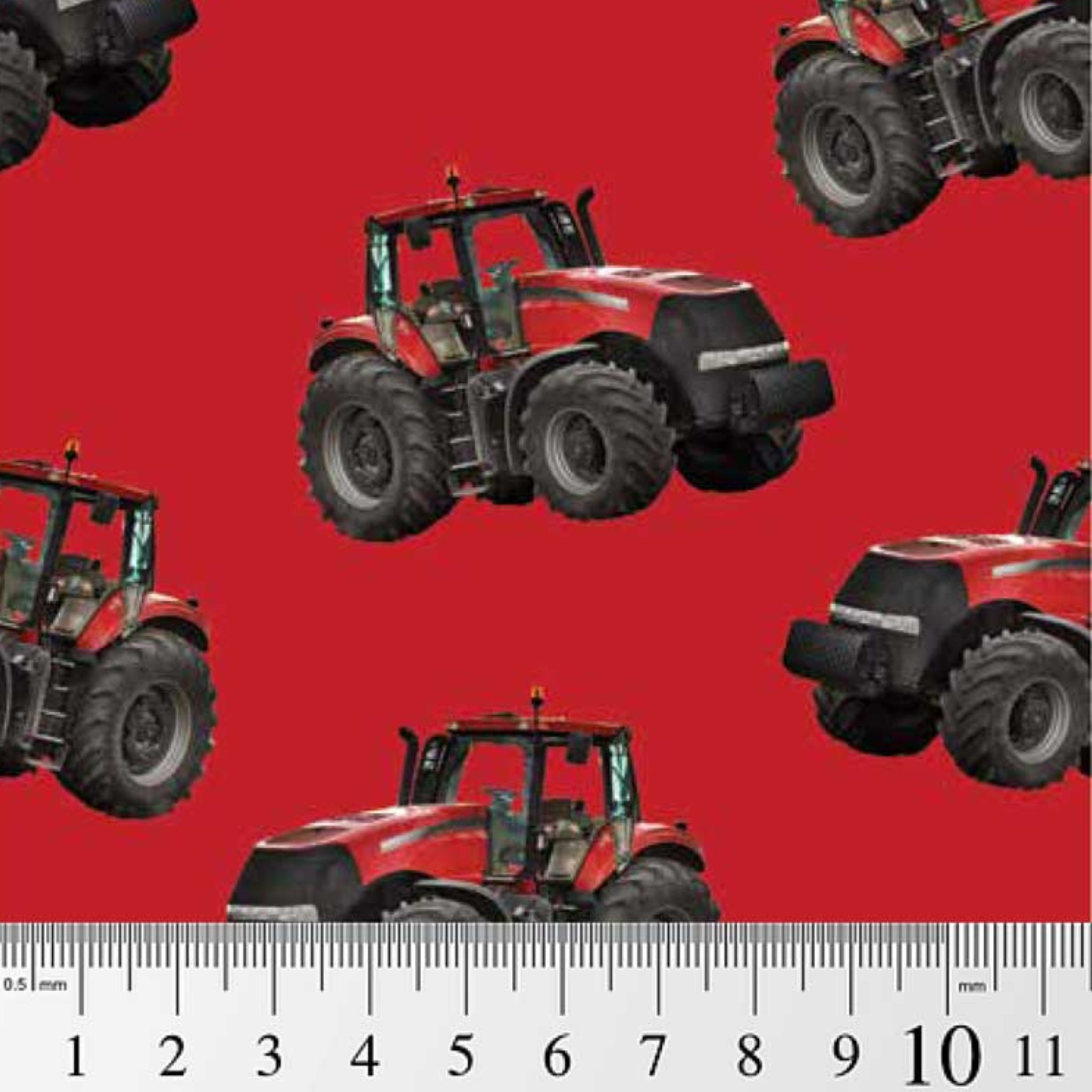 Red tractor toss fabric on solid red background, perfect for boys' quilting projects for farm lovers