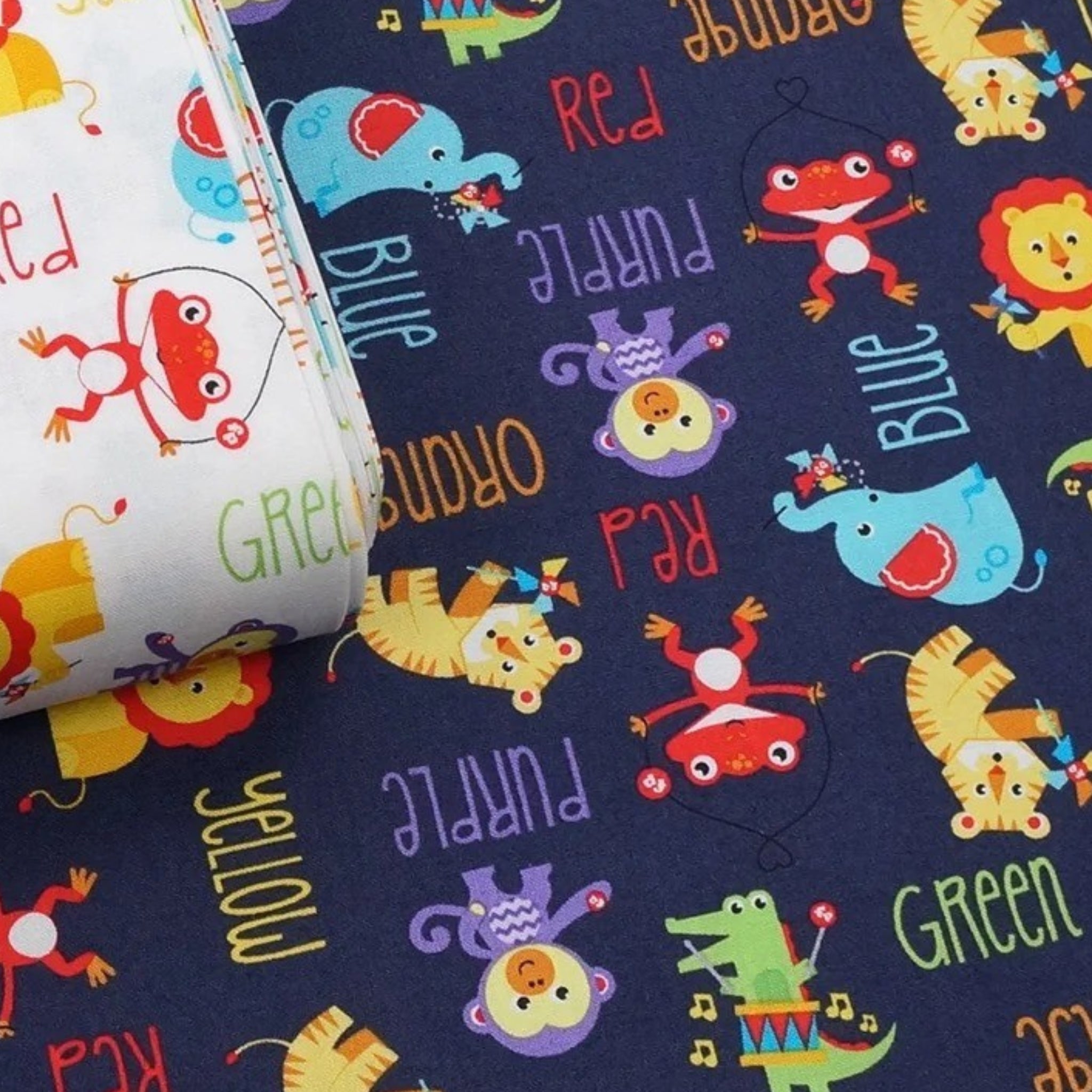 Navy and white fabric with tossed Fisher-Price animals and graphic colour word motifs