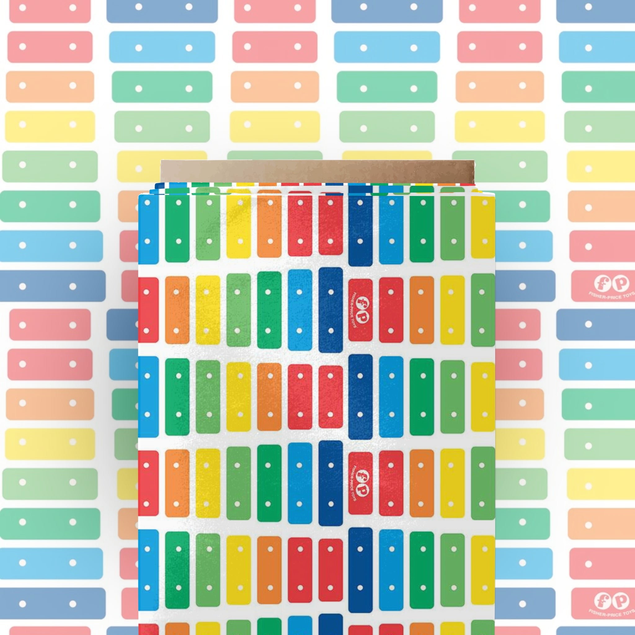 White fabric with a stripe pattern of the Fisher-Price Xylophone rainbow keys