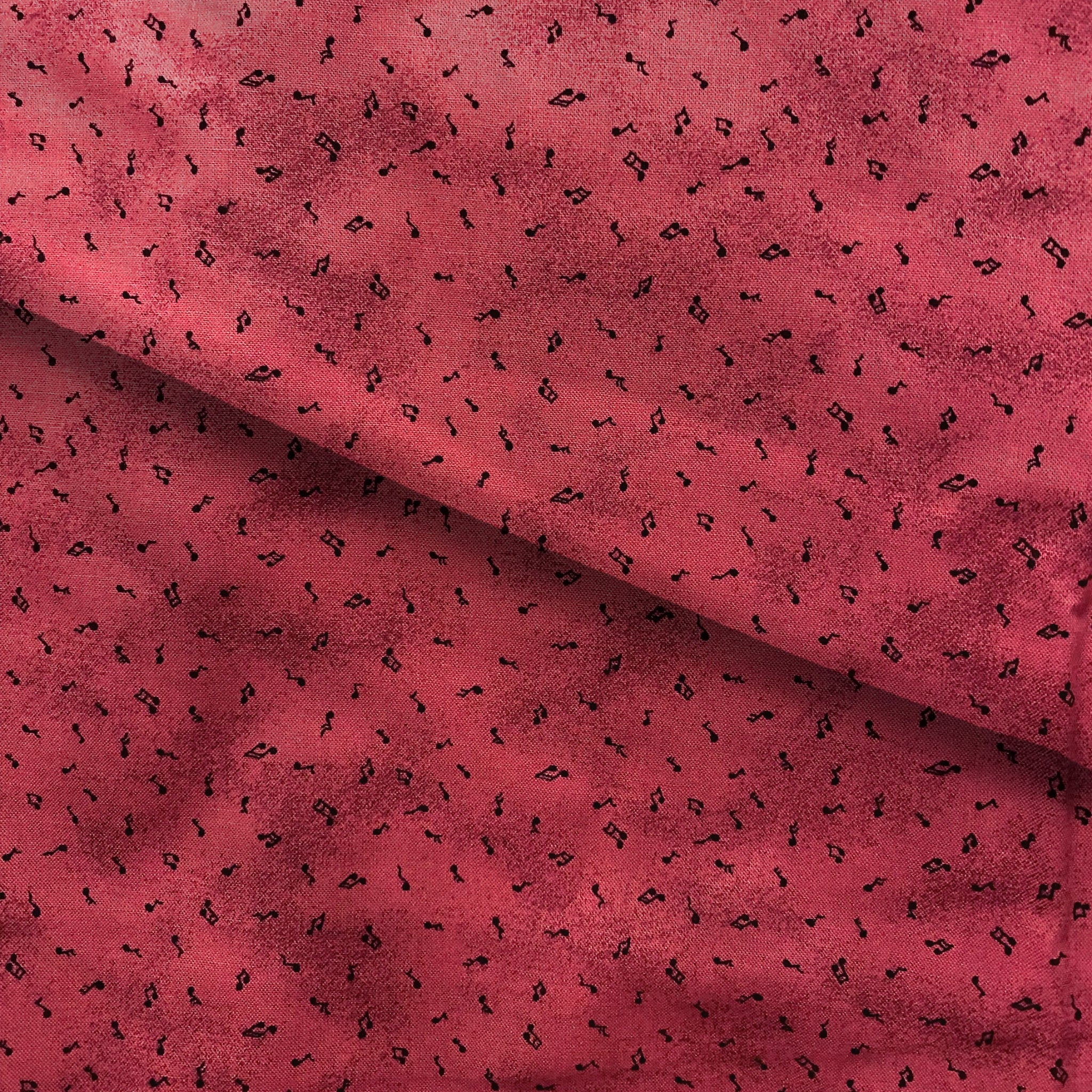Tossed music notes mottled raspberry red novelty blender fabric for music quilts sashing music teacher gifts and patchwork projects