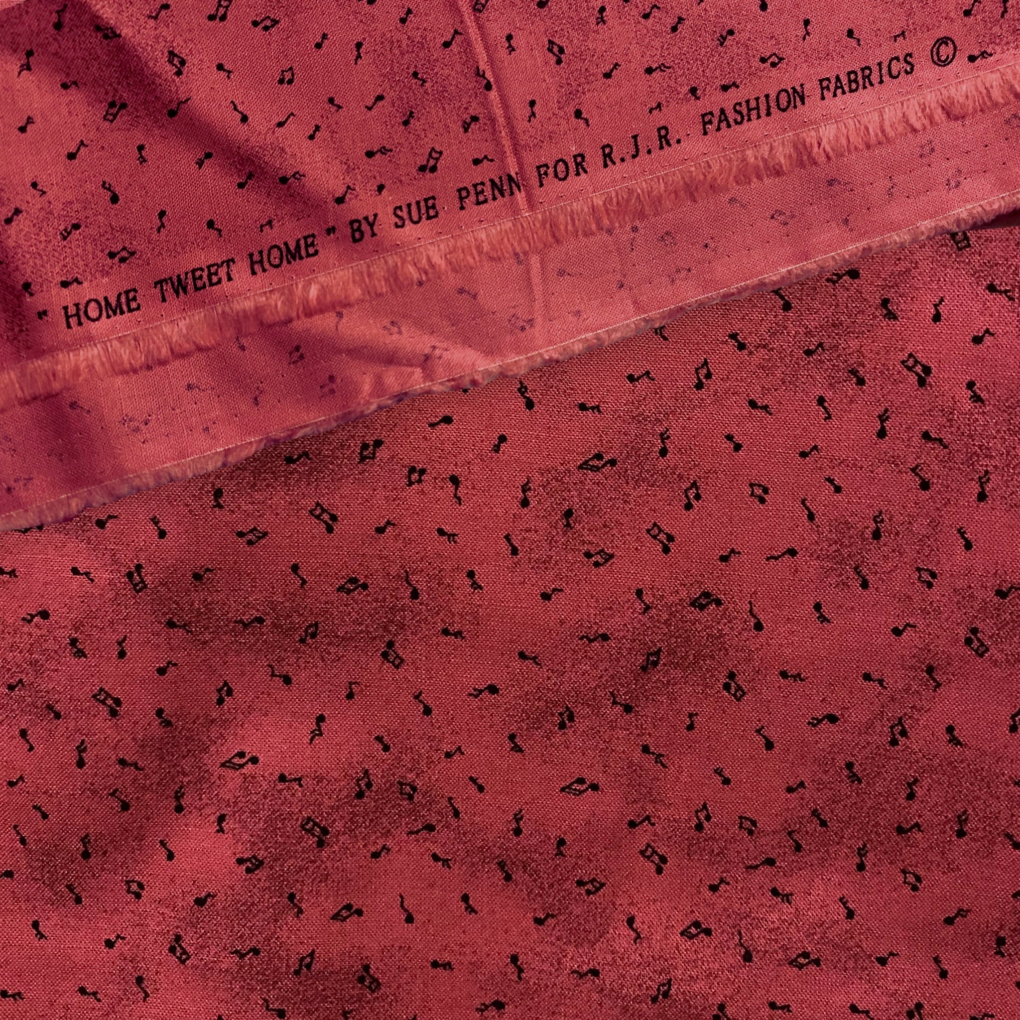 Tossed music notes mottled raspberry red novelty blender fabric for music quilts sashing music teacher gifts and patchwork projects