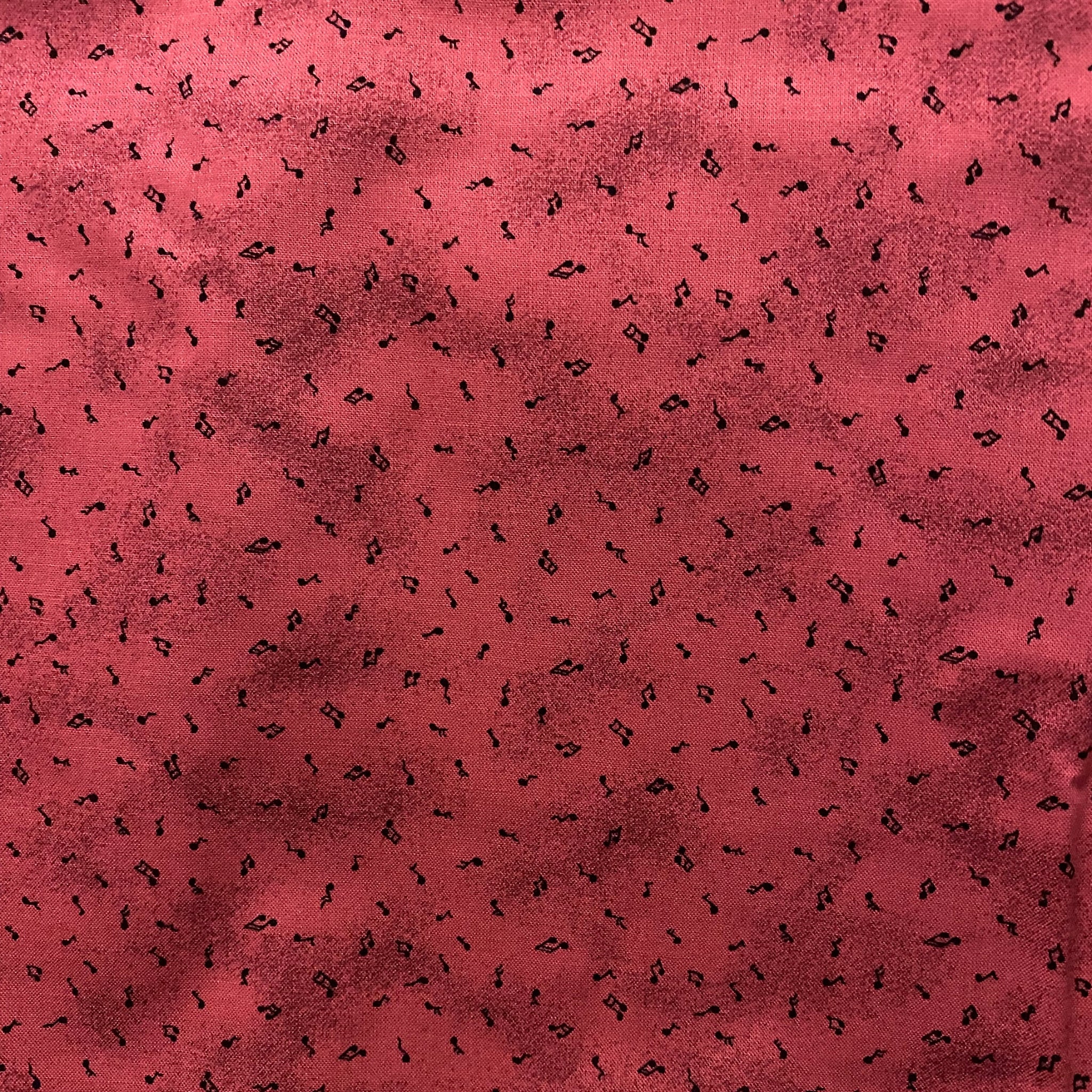 Tossed music notes mottled raspberry red novelty blender fabric for music quilts sashing music teacher gifts and patchwork projects