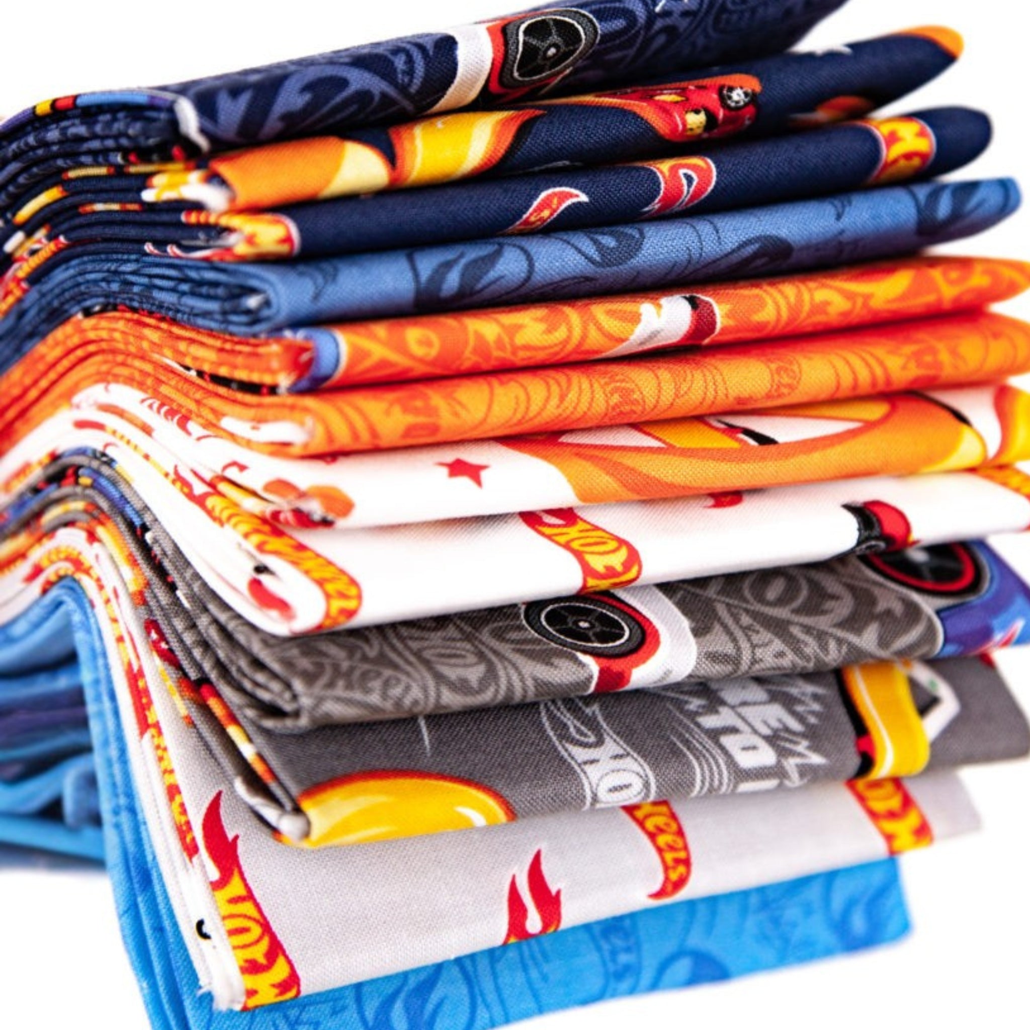 Hot Wheels kids fabric collection with blue, orange, grey, navy, and white coordinating race car track prints for boys projects
