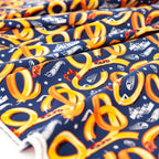 Hot Wheels-themed fabric with red race cars on yellow tracks on a navy blue background for boys quilts