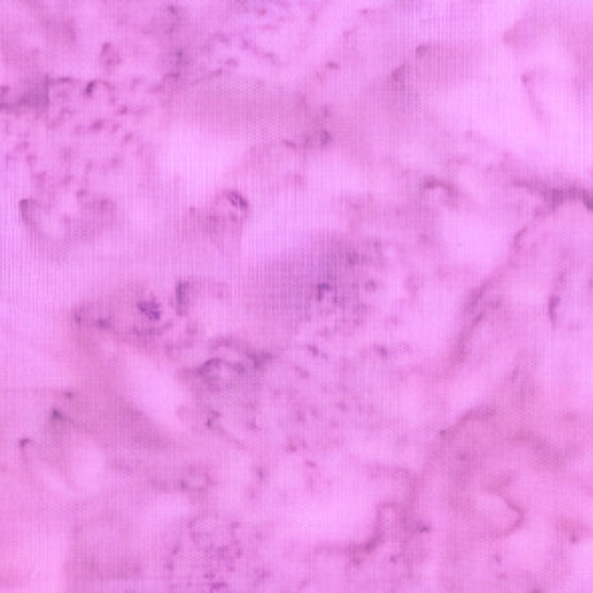 Soft pink-purple mottled batik blender fabric with subtle purple undertones for quilt backgrounds sashing and patchwork projects