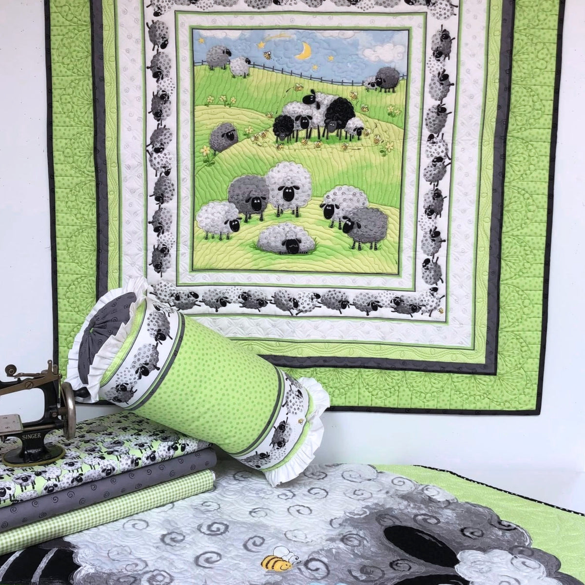 Lewe the Ewe green quilt panel finished wall hanging with sheep border bolster cushion and coordinate fabrics Susybee