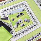 Lewe the Ewe green quilt panel sheep meadow scene with coordinate fabrics flat lay patchwork quilting project Susybee