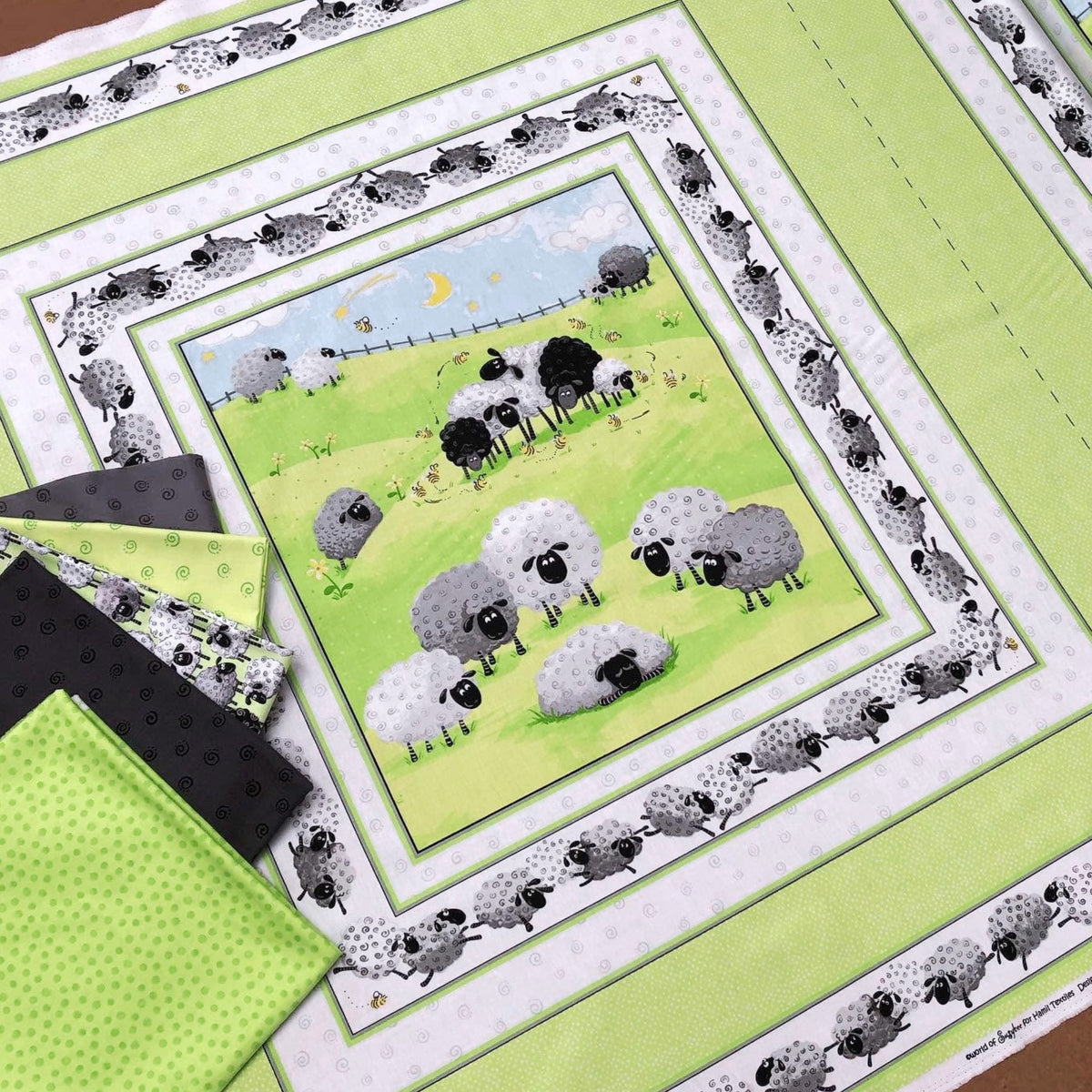 Lewe the Ewe green quilt panel sheep meadow scene with coordinate fabrics flat lay patchwork quilting project Susybee