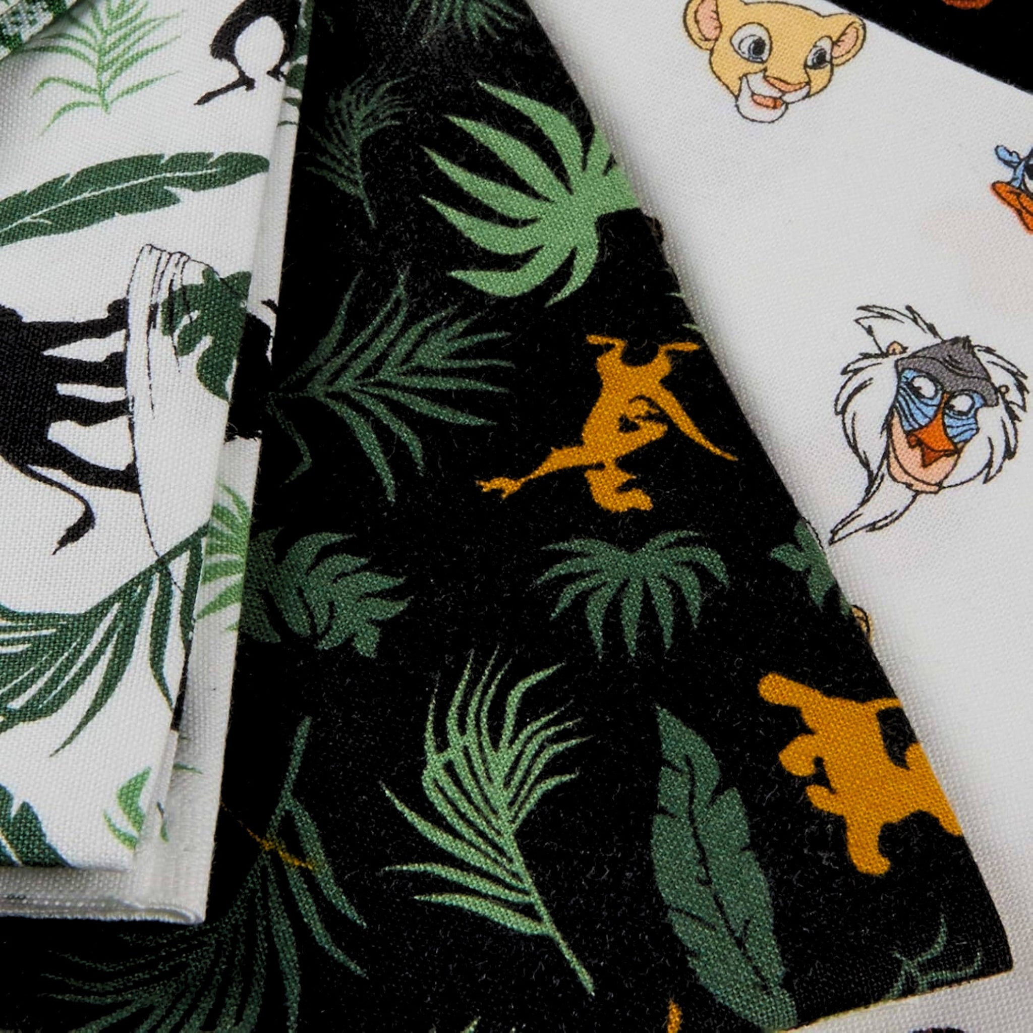 Disney Lion King fabric collection featuring character heads leaves and tropical prints for kids' quilts and patchwork sewing projects