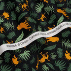 Disney Lion King Simba silhouettes tropical leaves black fabric for kids' quilts, jungle-themed projects and patchwork sewing projects