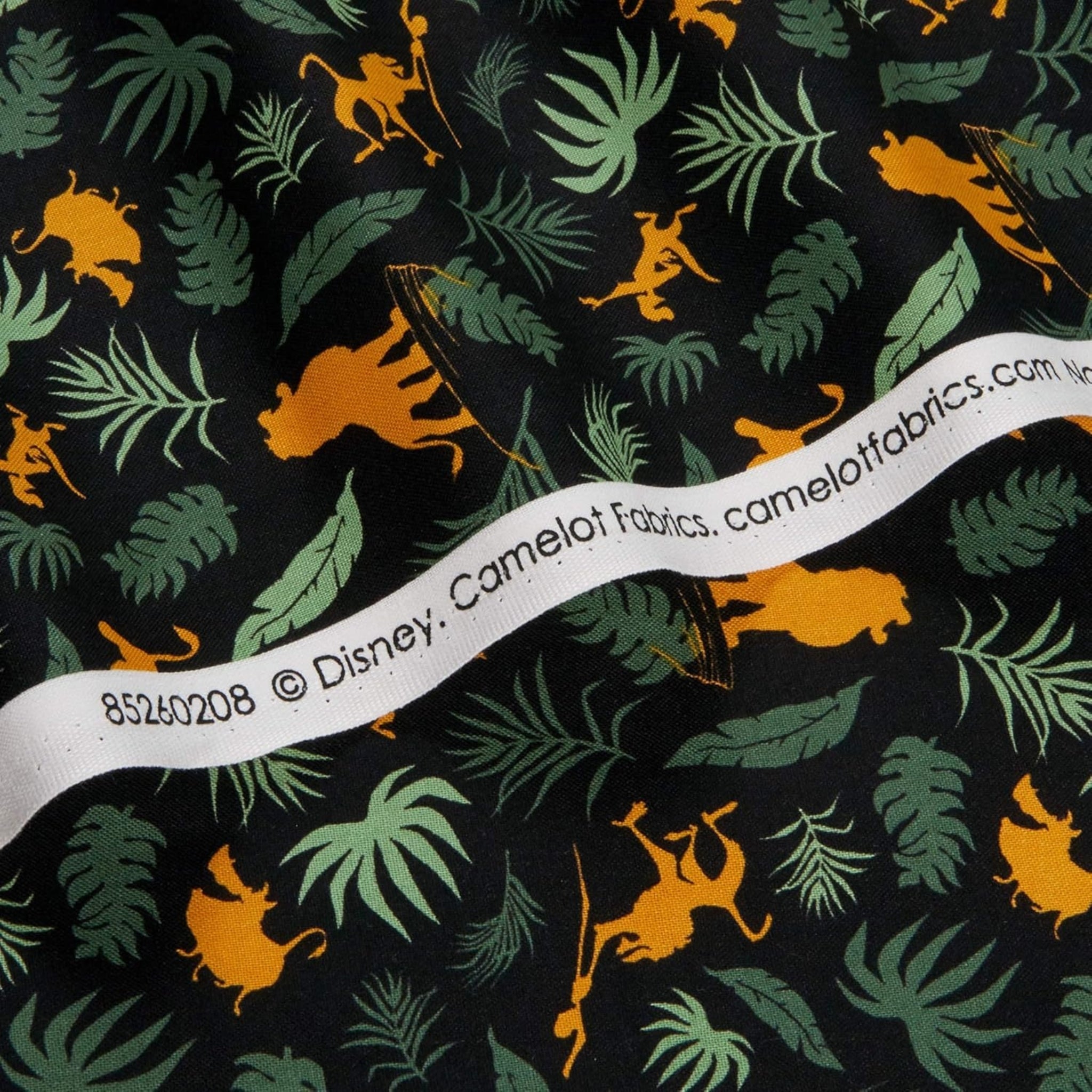 Disney Lion King Simba silhouettes tropical leaves black fabric for kids' quilts, jungle-themed projects and patchwork sewing projects