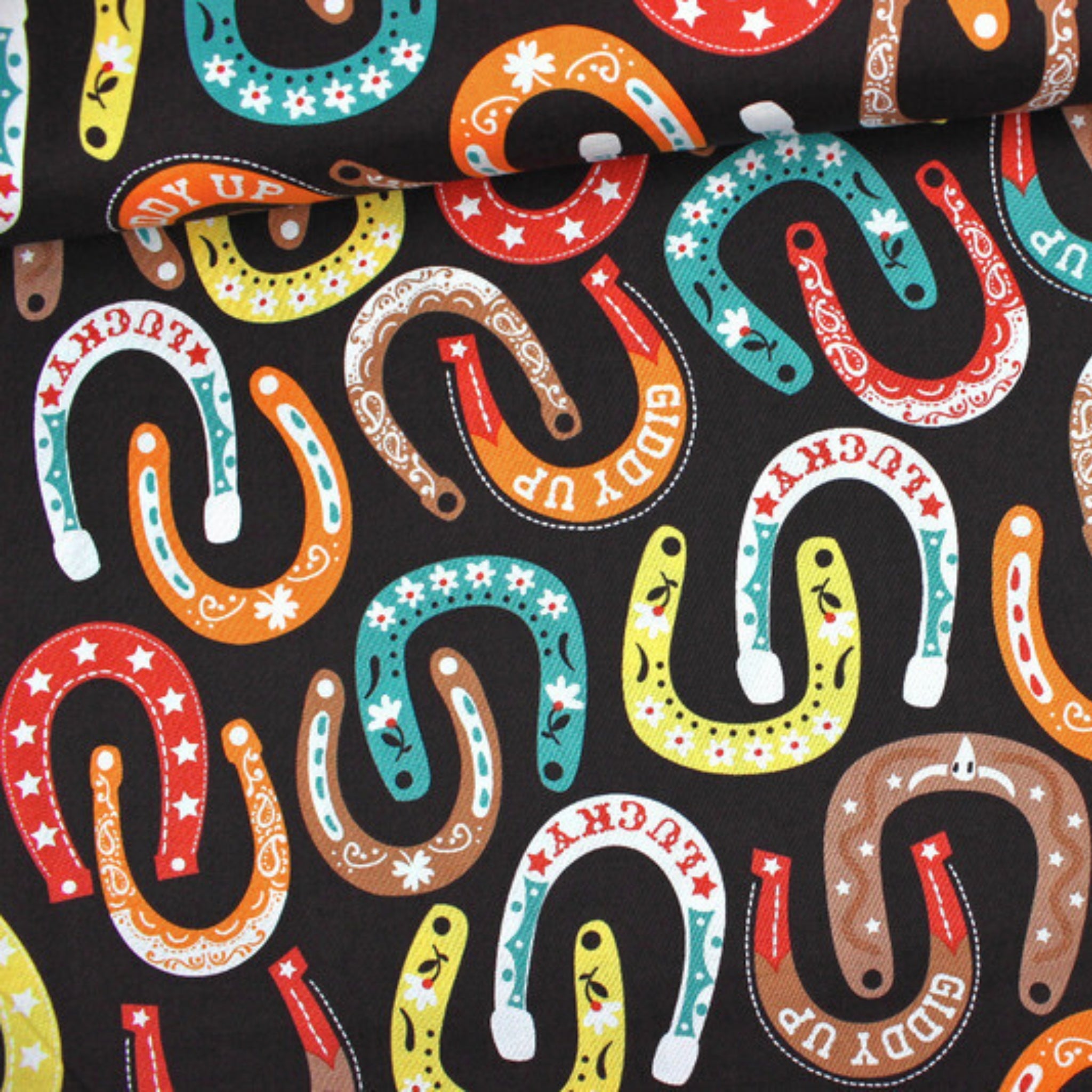 Lucky horseshoes paisley stars flowers colourful black fabric for Western horse-themed quilts bags and riding accessories