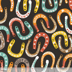 Lucky horseshoes paisley stars flowers colourful black fabric for Western horse-themed quilts bags and riding accessories